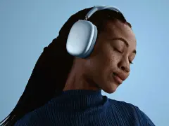 En kvinna med slutna ögon njuter av ljudet från sina ljusblå AirPods Pro Max 2.