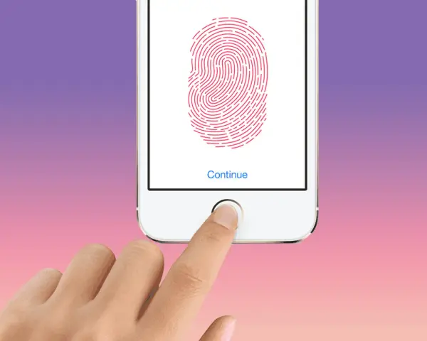 En finger placeras på hemknappen för att aktivera touch ID.